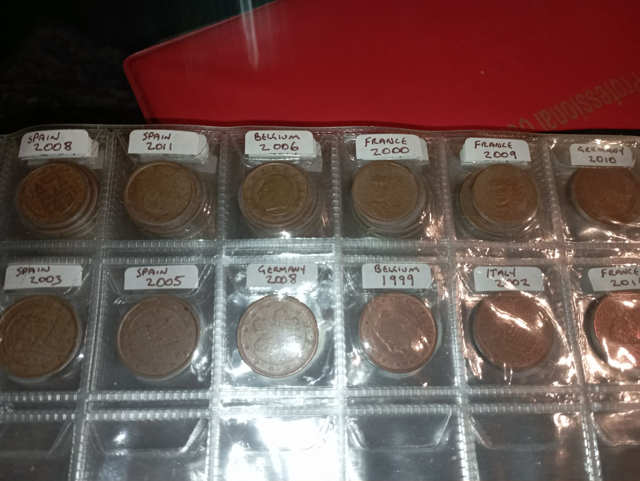 RED COIN BOOK WITH 44 CENT AND EURO COINS