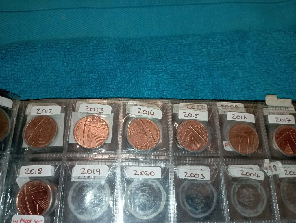 RED COIN BOOK WITH 45 BRITISH 1P COINS