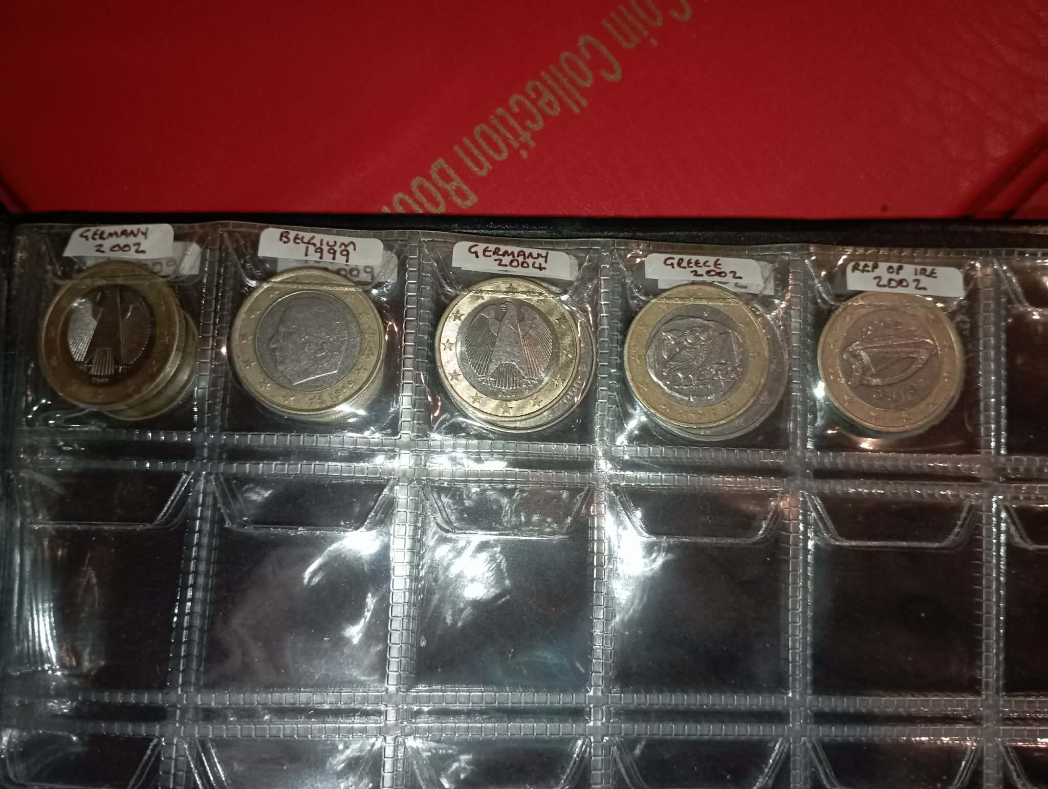 RED COIN BOOK WITH 44 CENT AND EURO COINS