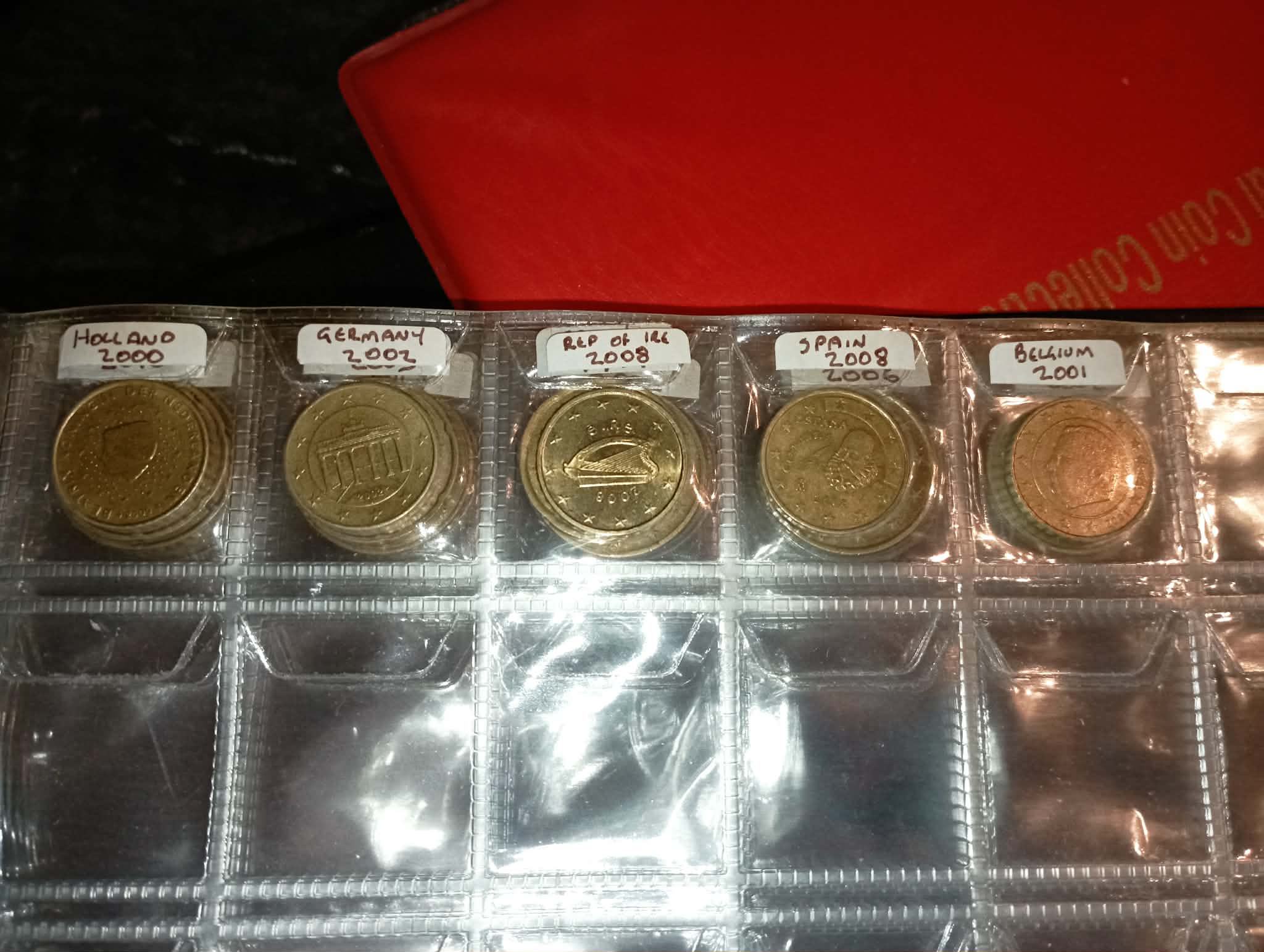 RED COIN BOOK WITH 44 CENT AND EURO COINS