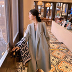 A minimalist mid-length woolen coat