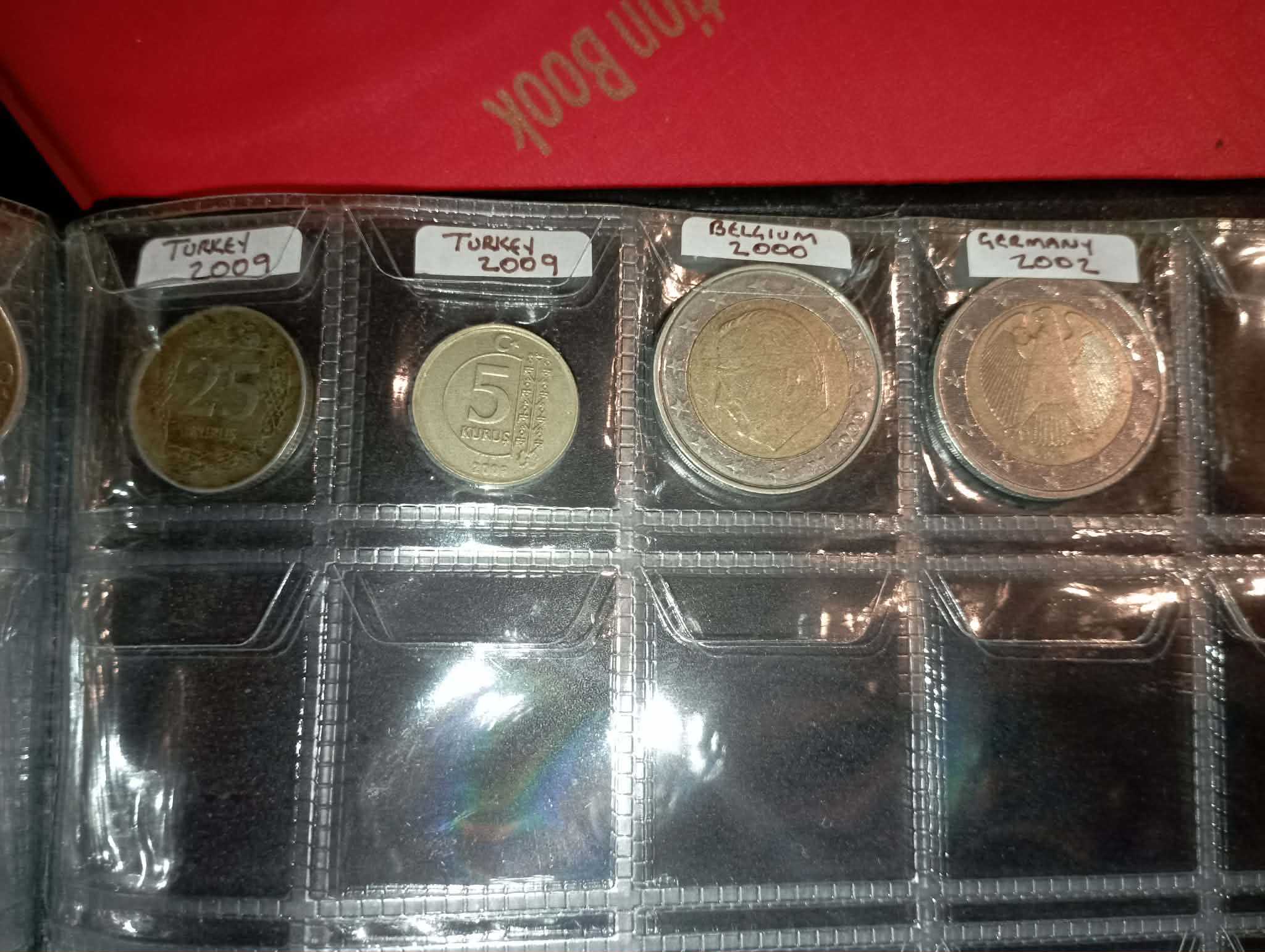 RED COIN BOOK WITH 44 CENT AND EURO COINS