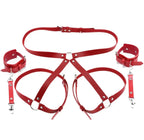 Leather handcuffs with garter and leg straps.