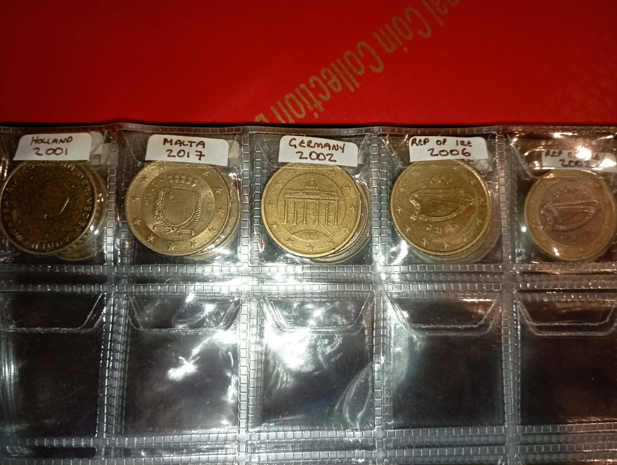 RED COIN BOOK WITH 44 CENT AND EURO COINS