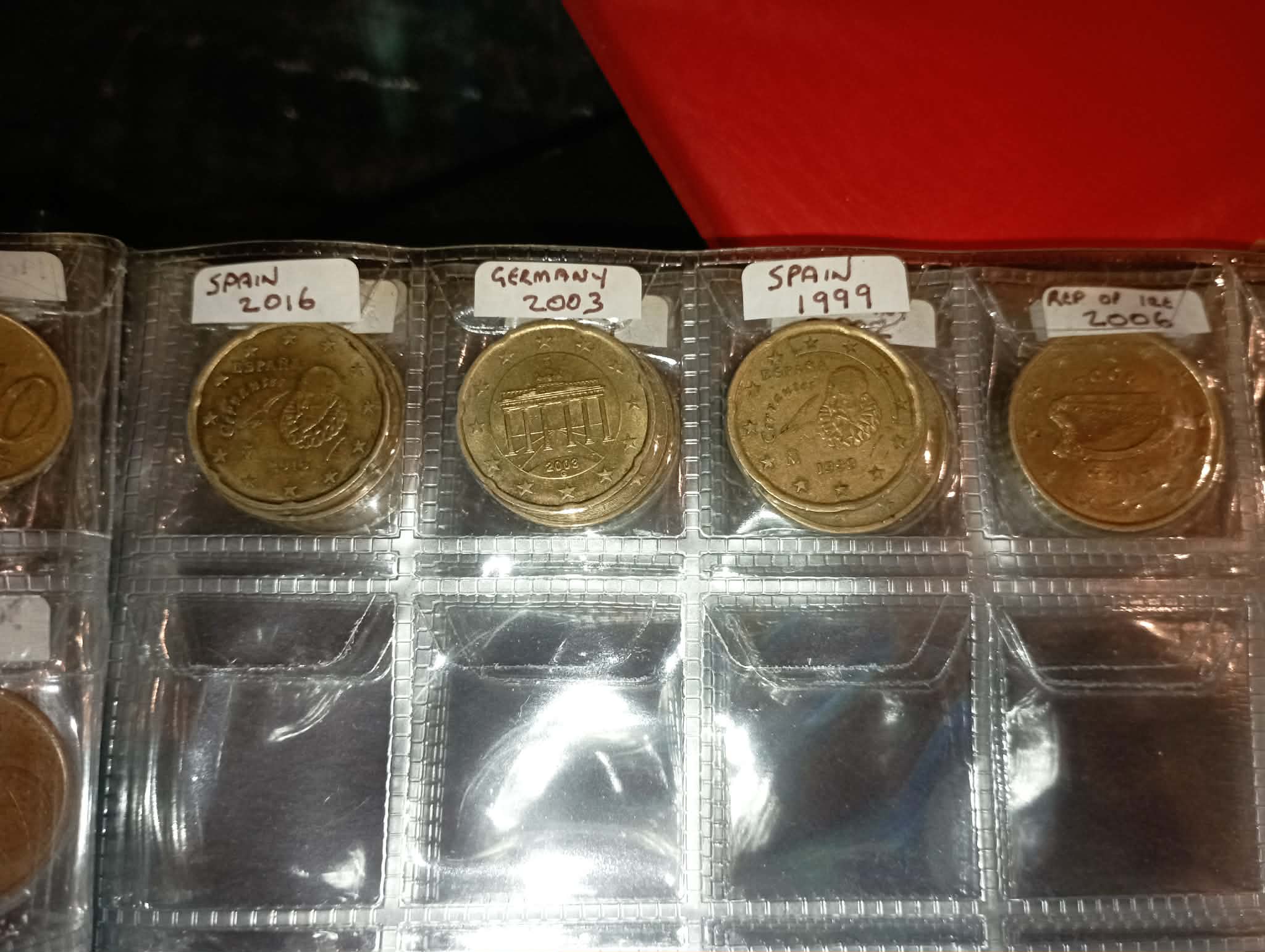 RED COIN BOOK WITH 44 CENT AND EURO COINS